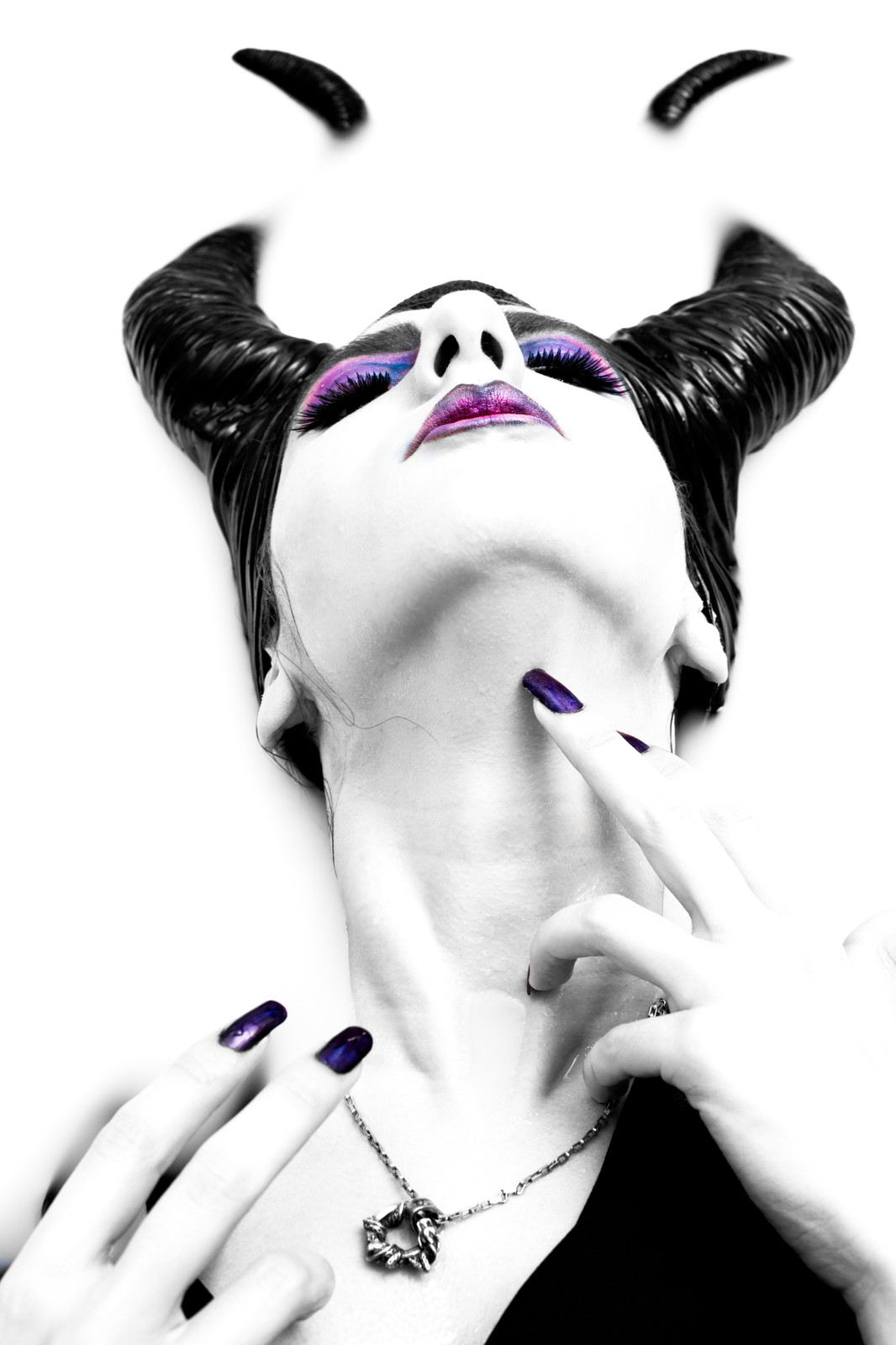 Expressive black-and-white portrait with theatrical makeup and costume