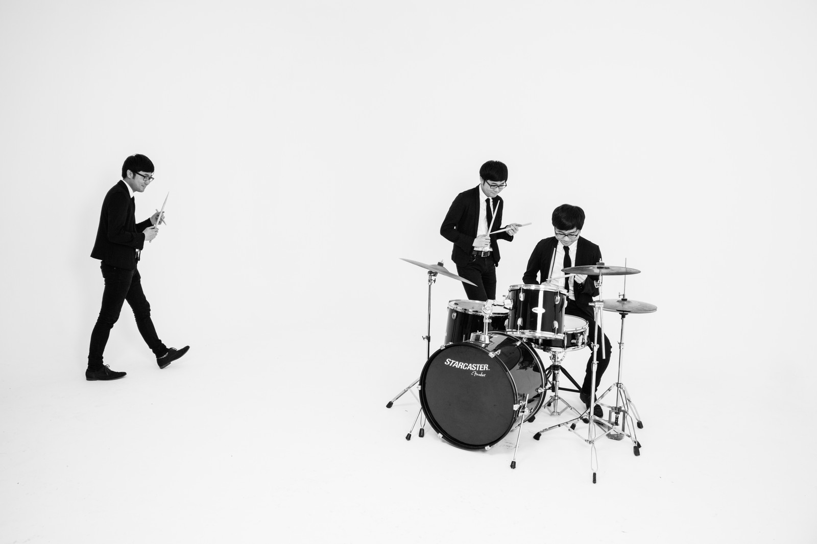 Black-and-white studio scene with a drummer and another performer