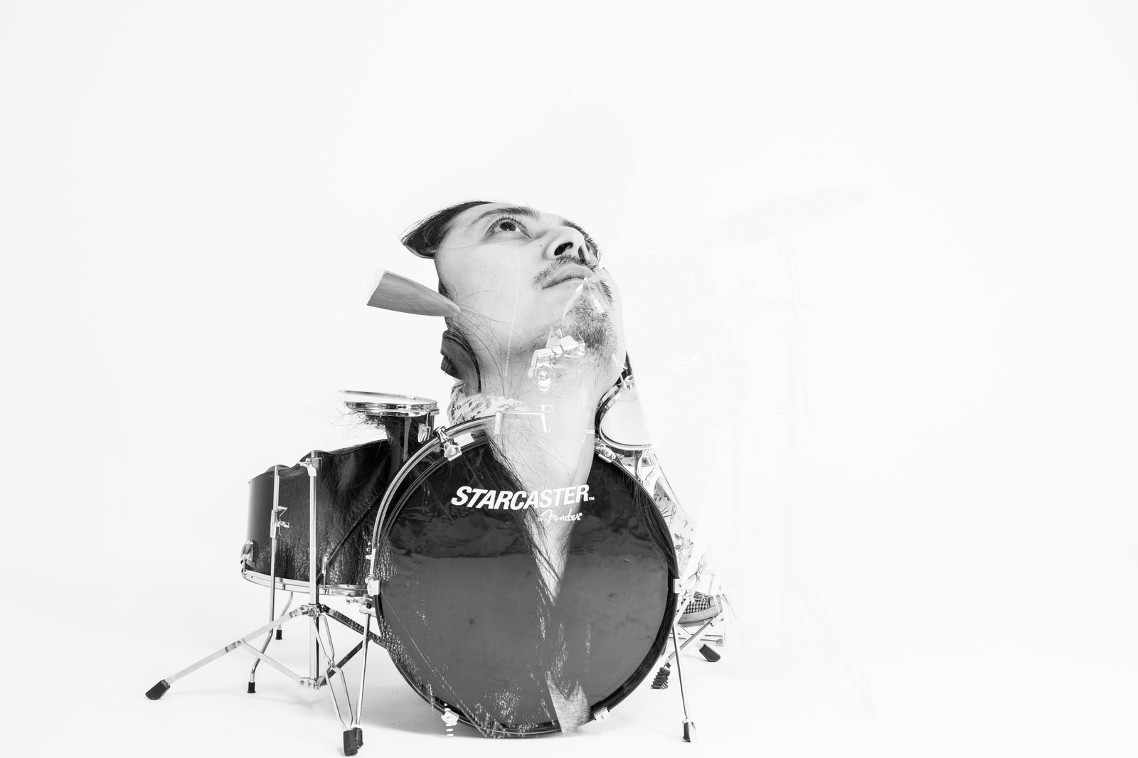 Black-and-white studio portrait of a person looking upward